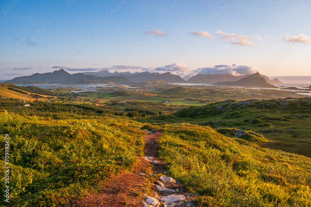 Wall mural View of Lofoten mountains and nature from a high mountain top, from Justadtinden towards Leknes. Summer sun, green nature, path.