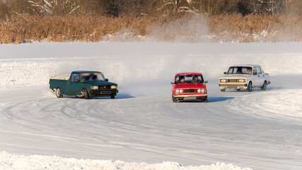 Car racing on vintage cars on ice, Drift car on ice, Auto ice racing, Racing on frozen body of water in winter Tinted, Selective Focus, Sun Flare