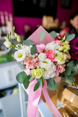 Beautiful arrangement of flowers in gift box at flower shop. Work of florist. Fresh cut flower