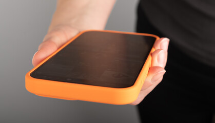 Hand holding mobile phone, using smartphone, closeup