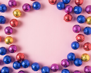 Creative layout of colored candy on pink background. Minimal hol