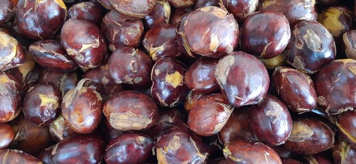 Close up of heap raw jengkol or dogfruit placed on stall of market ready to sold. Jengkol background