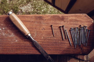 Top view of metal screws and putty knife