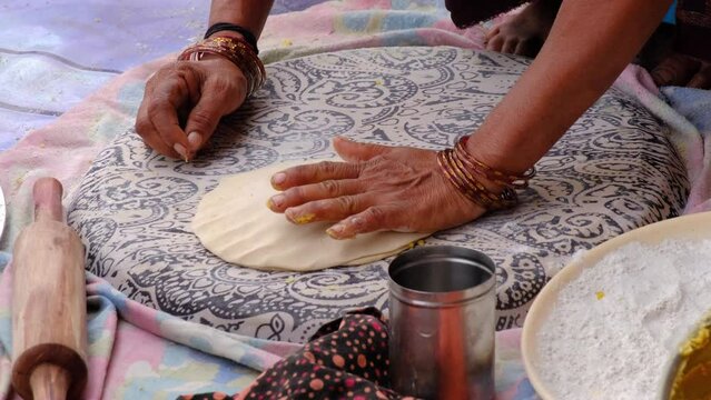 Indian Women Preparing mande ( PURAN POLI ) - typical Maharashtrian Sweet food in Bhimthadi Jatra, Pune, To uplift the culture and traditional Food with an active platform.
