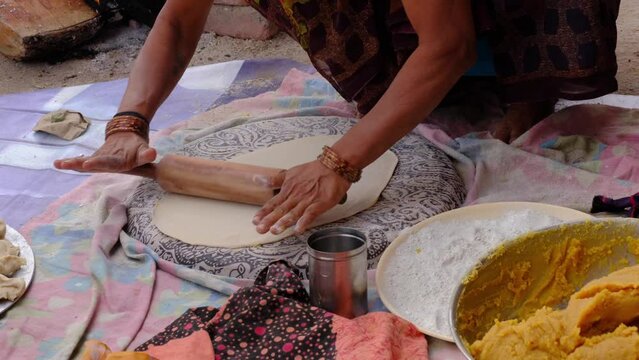 Indian Women Preparing mande ( PURAN POLI ) - typical Maharashtrian Sweet food in Bhimthadi Jatra, Pune, To uplift the culture and traditional Food with an active platform.