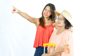 Two diverse generation Asian senior old and adult women wearing casual clothes, standing on isolated white background cut out, smiling with happiness, pointing away. Travel, Summer, Vacation Concept.