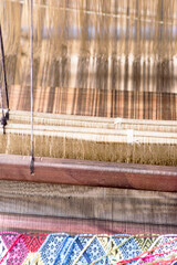 A woman works a handloom in Laos, Lao Prabang region. January 12, 2024