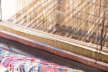 A woman works a handloom in Laos, Lao Prabang region. January 12, 2024