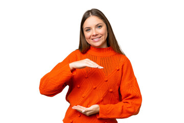 Young blonde woman over isolated chroma key background holding copyspace imaginary on the palm to...