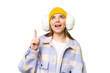 Young blonde woman wearing winter muffs over isolated chroma key background pointing up and...