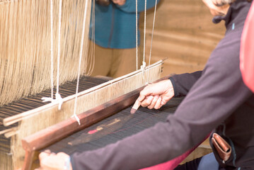 A woman works a handloom in Laos, Lao Prabang region. January 12, 2024