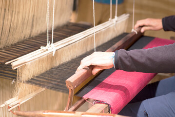 A woman works a handloom in Laos, Lao Prabang region. January 12, 2024