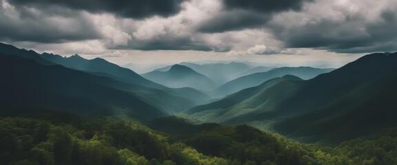Amazing wild nature view of layer of mountain forest landscape with cloudy sky.  - obrazy, fototapety, plakaty