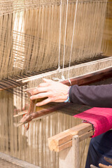 A woman works a handloom in Laos, Lao Prabang region. January 12, 2024