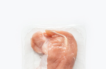Fresh raw meat in package in plastic box. Close-up of meat in plate over light background with copy space