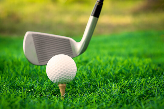 Golf ball close up on tee grass on blurred beautiful landscape of golf background. Concept international sport that rely on precision skills for health relaxation