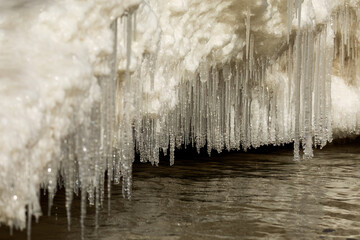Water and frost create ice icicles on ice floes.