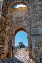 View of the entrance gate to the castle of Jimena de la Frontera, a beautiful village in the province of Cadiz, Andalusia, Spain.