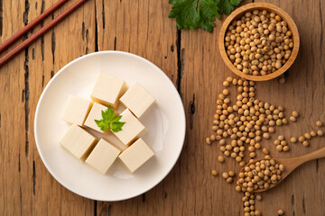 Fresh Sliced Soft Tofu soy bean curd on white plate.Top view