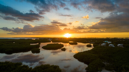 Sunset over Rock Harbor mangroves with reflection on water in Florida Keys