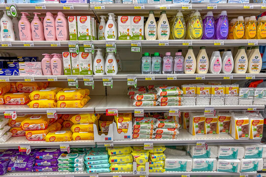 Italy - January 11, 2024: Hygiene and baby care products in packs of various types and brands displayed for sale in Italian supermarket