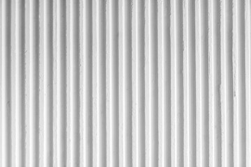 Old white concrete background wall with vertical line ribbed. Stripes as a texture.