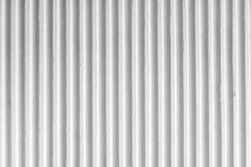 Old white concrete background wall with vertical line ribbed. Stripes as a texture.