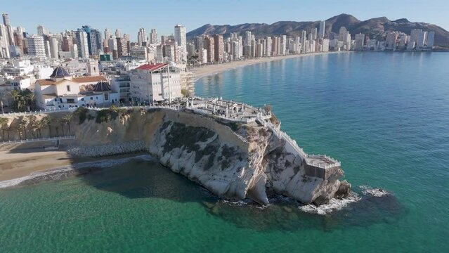 High angle view drone shot of tourist town of Benidorm showing old town, Plaza del Castell, balcon del mediterraneo and skyscrapers from the sea