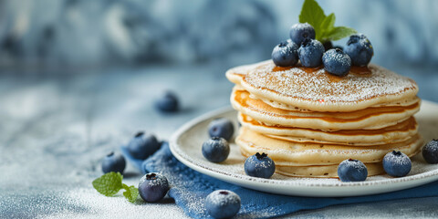 Fluffy tasty pancakes with blueberries on a plate in bright daylight. Rustic shabby chic feel. Pancake Day. Banner with empty space for text. - Powered by Adobe