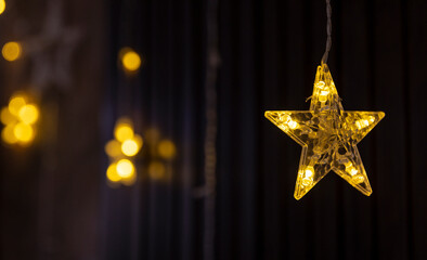 transparent stars with yellow diode lamps on a dark background, New Year and Christmas theme