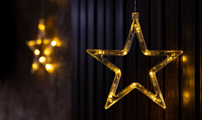 transparent stars with yellow diode lamps on a dark background, New Year and Christmas theme