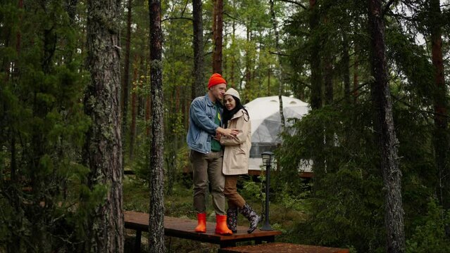 Two Lovers Embracing In Nature, Resting In Amazing Camping In Forest, Modern Futuristic Architecture