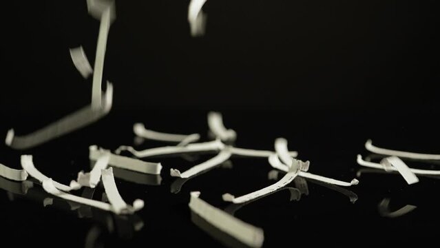 Shredding confidential documents with lorem ipsum text, maintaining data security and privacy. Businesses, government agencies, or personal disposal of sensitive information through shredding.