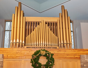 Catholic Church. Pipes of pipe organ in church sanctuary. Above alter