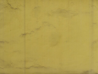 Dirty yellow wall with bumpy surface texture