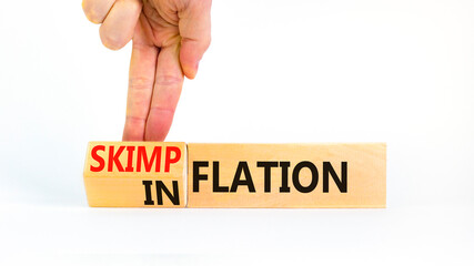 Inflation or skimpflation symbol. Concept words Inflation Skimpflation on beautiful wooden blocks. Beautiful white background. Businessman hand. Business inflation skimpflation concept. Copy space
