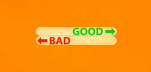Good or bad symbol. Concept word Good or Bad on beautiful wooden stick. Beautiful orange table orange background. Business and good or bad concept. Copy space.