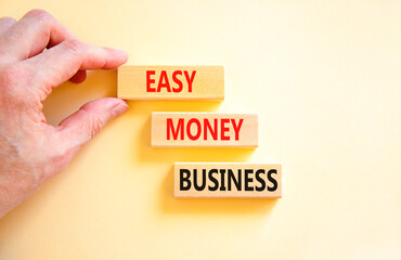 Easy money business symbol. Concept words Easy money business on beautiful wooden blocks. Beautiful white table white background. Businessman hand. Easy money business concept. Copy space.
