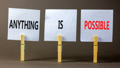 Anything is possible symbol. Concept words Anything is possible on beautiful white paper on clothespin. Beautiful grey table grey background. Business anything is possible concept. Copy space.