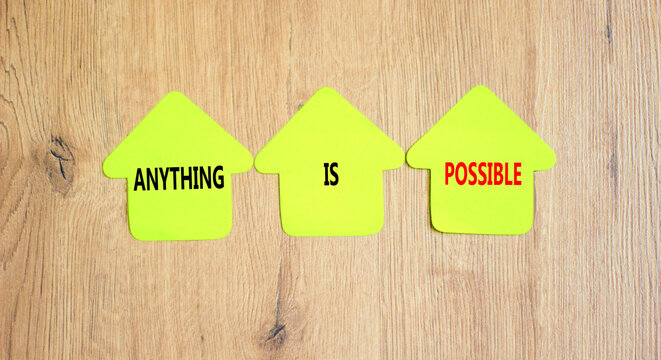 Anything is possible symbol. Concept words Anything is possible on beautiful yellow paper houses. Beautiful wooden table wooden background. Business anything is possible concept. Copy space.