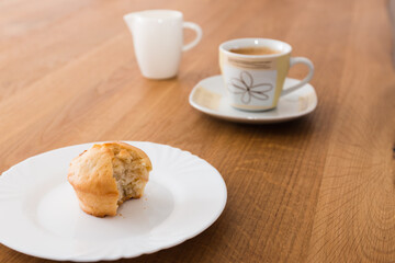 Bite-sized muffin with coffee and milk for breakfast