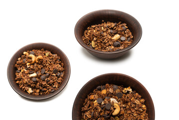 Chocolate granola cereal with nuts in a bowl background.