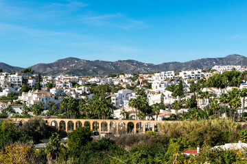 Fototapeta na wymiar White houses in the city of Nerja, Andalusia, Spain. View of the city and mountains.