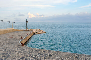 The last part of the wharf: panoramic sea view in front of the horizon. Serene sunset on the sea.