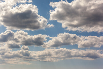 Blue sky background with clouds. Horizontal photo.