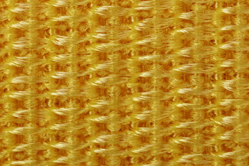 Extreme close up of abstract yellow nylon fabric texture as background