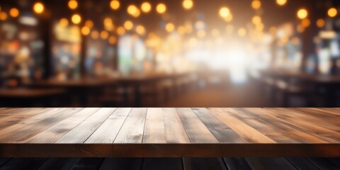 Blurry restaurant interior background with empty wooden table top - perfect for product display or montage.