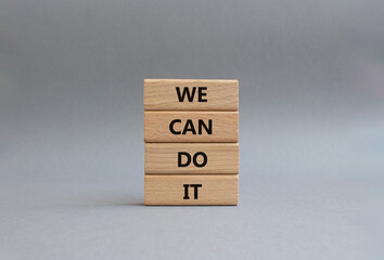 We can do it symbol. Concept words We can do it on wooden blocks. Beautiful grey background....