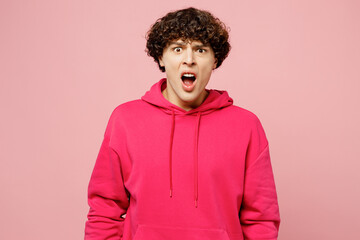 Obraz na płótnie Canvas Young displeased disappointed sad mad man he wearing hoody casual clothes look camera with opened mouth scream shout isolated on plain pastel light pink background studio portrait. Lifestyle concept.
