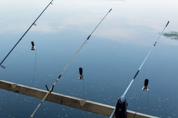 Fishing Rods with Stretched Lines and Bells over Calm Water — Recreational Angling Scene